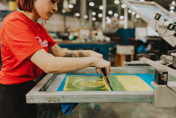 Image of person screen printing custom apparel